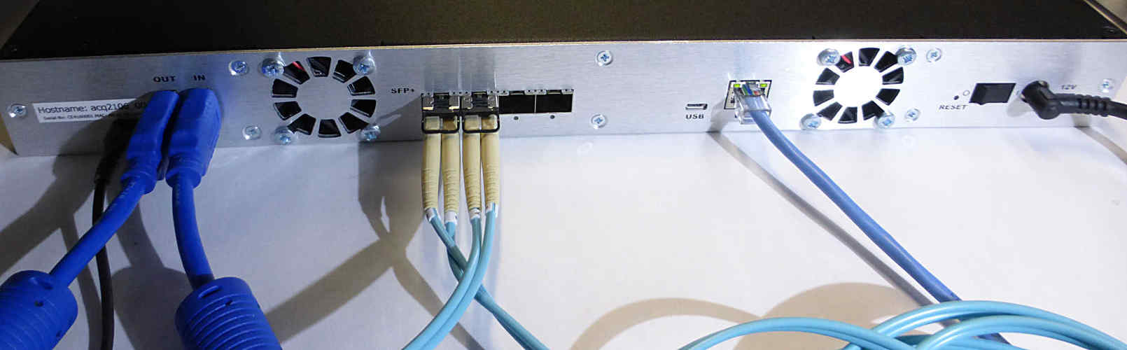 Click to enlarge ACQ2106 rear panel showing 4 x SFP fiber-optic ports, SYNC cable and Ethernet.